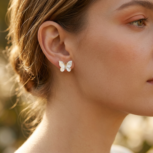 Butterfly mother shell earrings worn on model ear