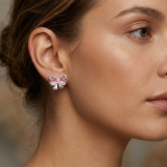 Gradient heart earrings worn on model ear