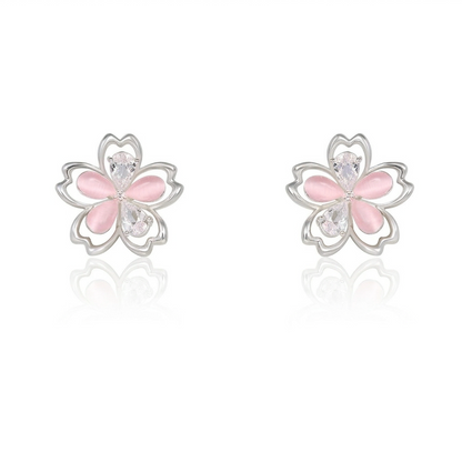 Hollow asymmetrical flower earrings on white background