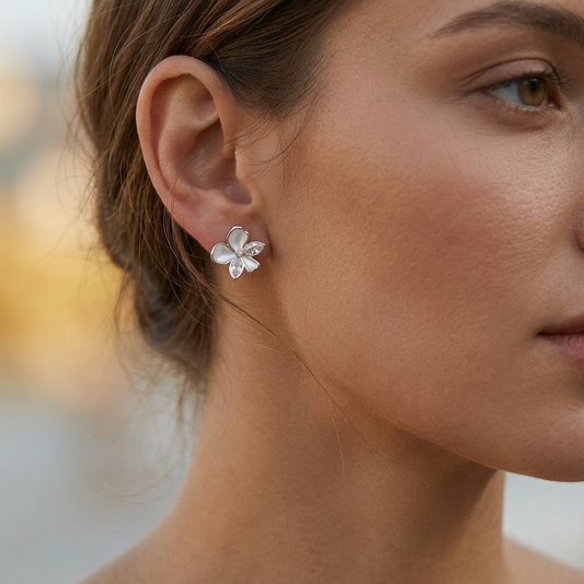 Hollow bow pearl earrings worn on model ear