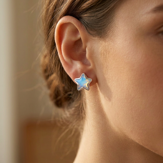 Painted flower stud earrings worn on model ear