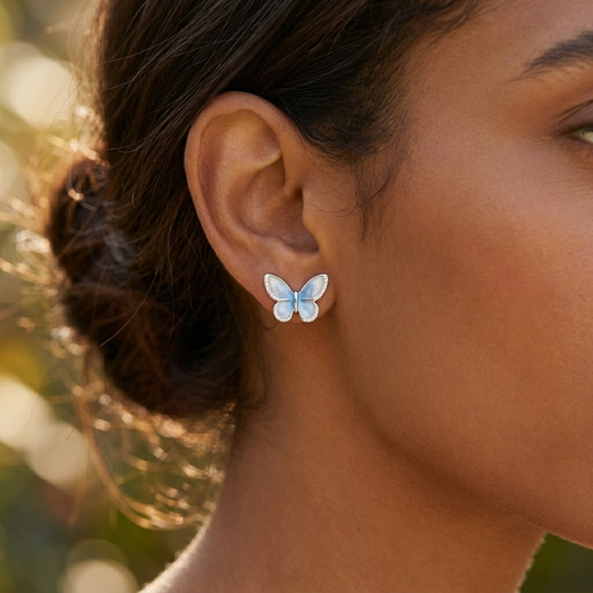 Light blue crystal star earrings worn on model ear