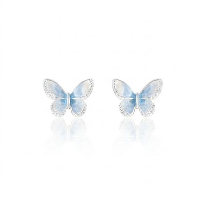 Light blue crystal star earrings on white background
