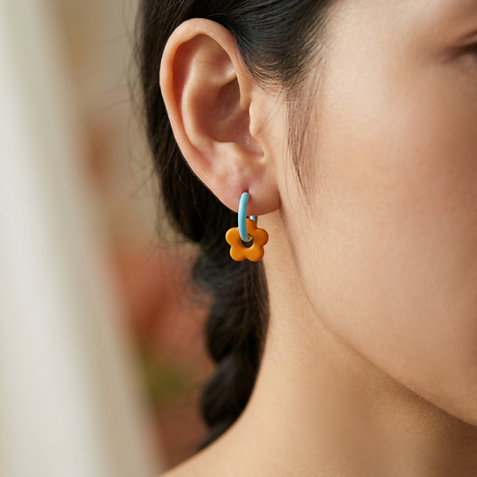 Daisy pearl earrings worn on model ear