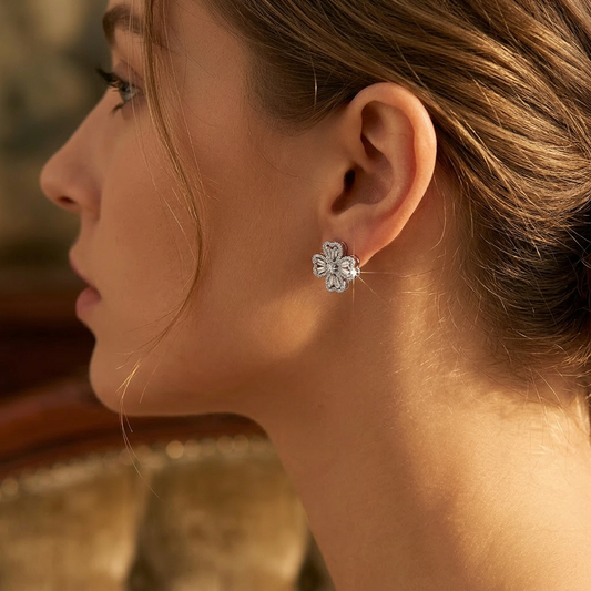 Rotating four-leaf clover earrings worn on model ear