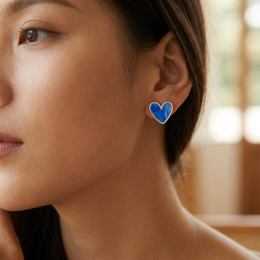 Klein blue love heart earrings on white background
