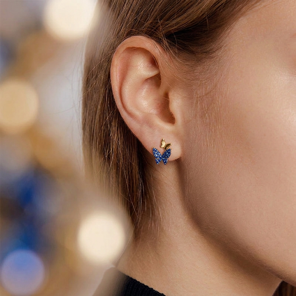Colorful butterfly earrings worn on model ear