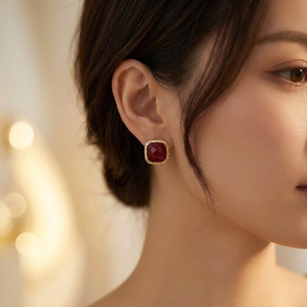 Wine red resin earrings worn on model ear